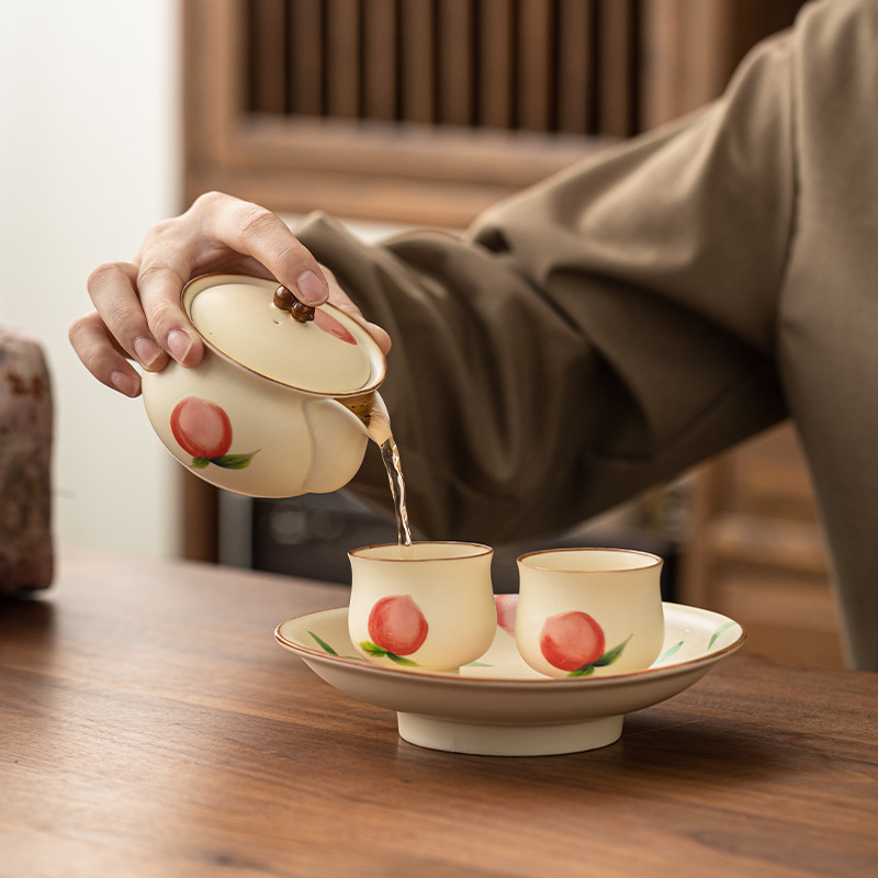 Màu hồng vẽ tay gốm sứ màu be nước đào nắm tay ấm chén cá nhân bộ trà Kung Fu bộ quà tặng bán buôn
