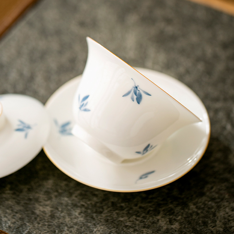 Vẽ tay phong lan trắng sứ nắp bát trà cốc trà đơn ba tài năng bộ trà gốm sứ kungfu bán buôn cốc trà