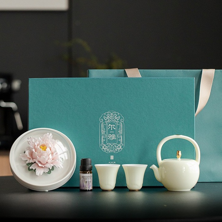 Bộ ấm trà quà tặng sáng tạo Bộ ấm trà chùm hương hoa sứ kẹp tay Fanghua Hộp quà một ấm hai cốc