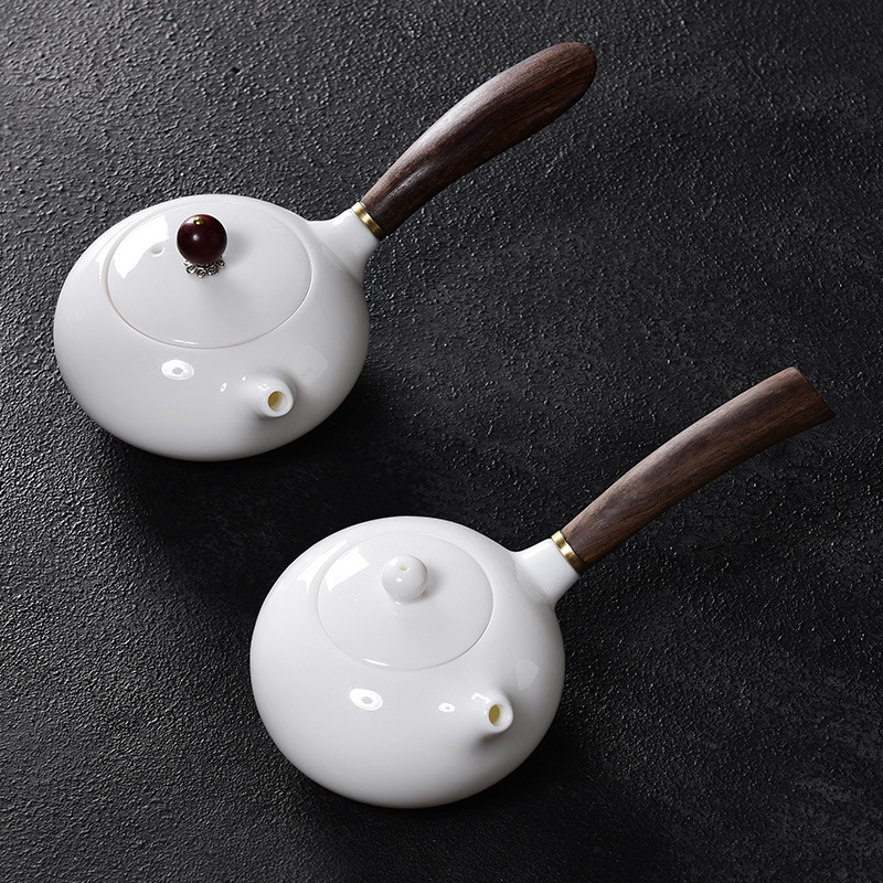Ấm trà sứ trắng ngọc bích Dehua ấm trà gốm sứ bên tay cầm gia dụng có lưới lọc bộ trà Kung Fu đơn ấm bán buôn