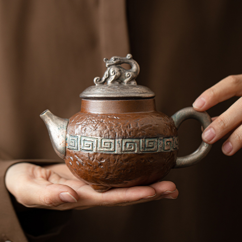 Ấm trà mạ bạc cổ phong cách Trung Quốc ấm trà gốm sứ gia dụng ấm tay cầm chùm dụng cụ trà Kung Fu ấm trà lọc lỗ bóng ấm đơn