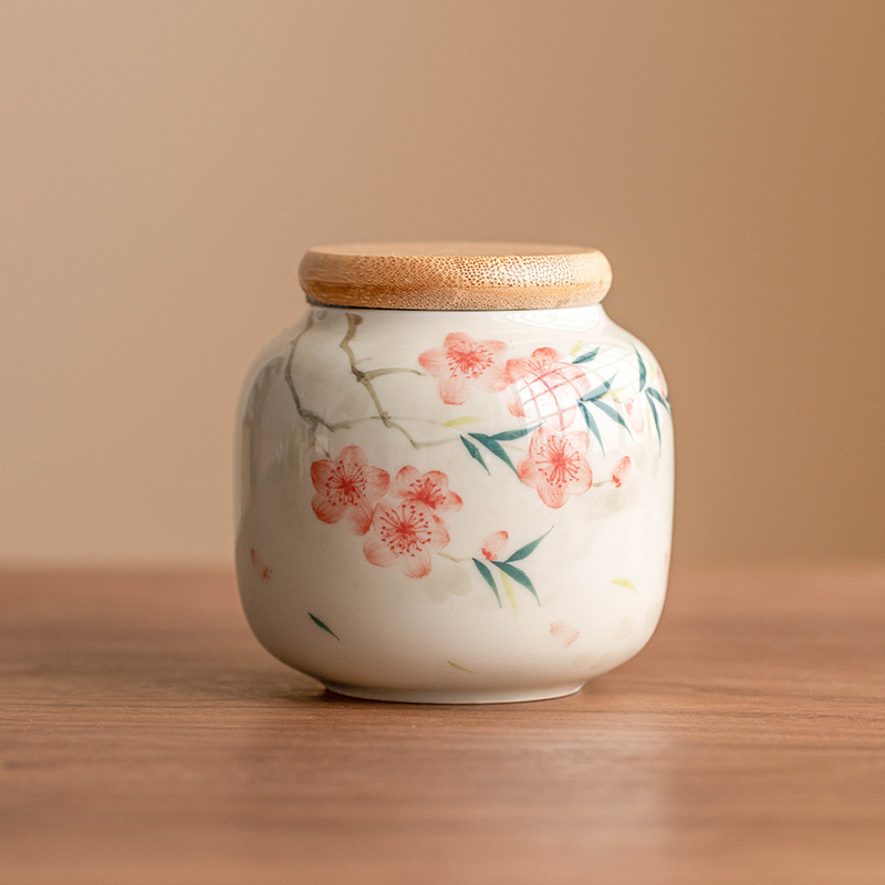 Bể trà ba nhân dân tệ hoa đào vẽ tay, bể kín, bể chứa trà cầm tay chống ẩm, bể chứa, bộ trà đơn gốm sứ