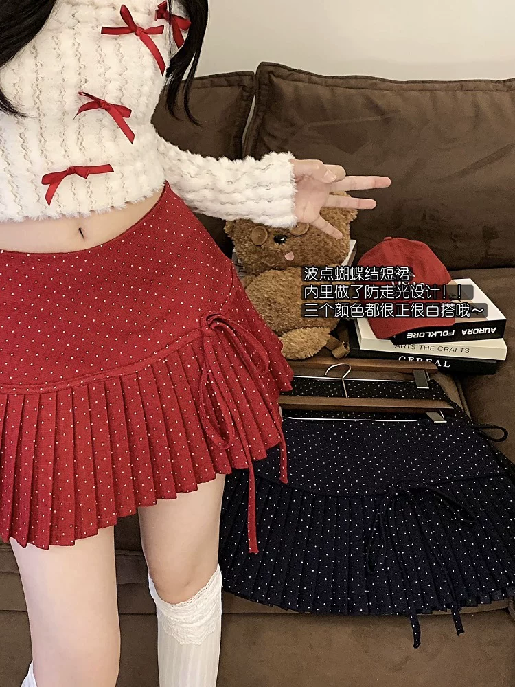 Váy xếp ly chấm bi màu đỏ thắt nơ cho nữ mùa thu đông, váy ngắn lưng cao chống lộ, váy chữ A nhỏ nhắn gợi cảm