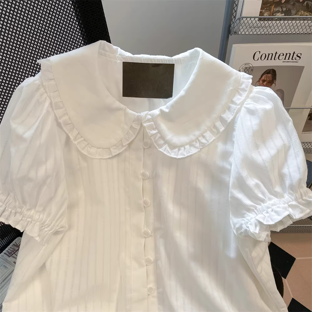 Áo sơ mi nữ tay ngắn cổ búp bê kiểu Pháp cổ điển màu trắng, kiểu mới năm 2025, đẹp và độc đáo, kiểu dáng regular, tay lửng.