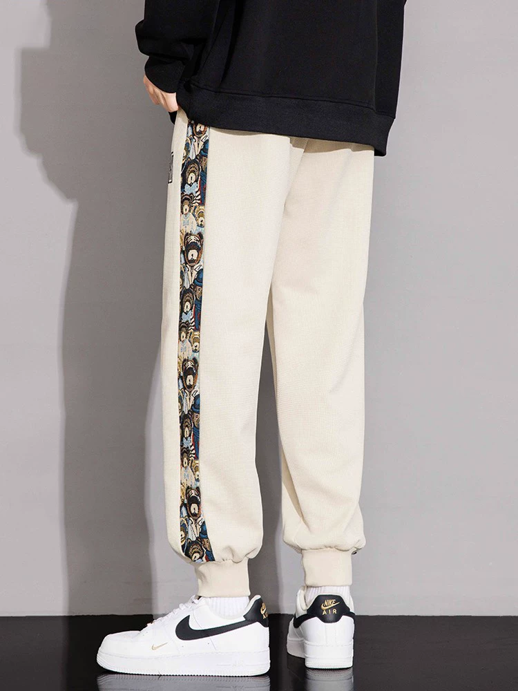 Quần jogger thể thao nam Jeanswest theo xu hướng quốc gia, kiểu mới xuân thu 2026, quần ống đứng size lớn phong cách Mỹ cao cấp.