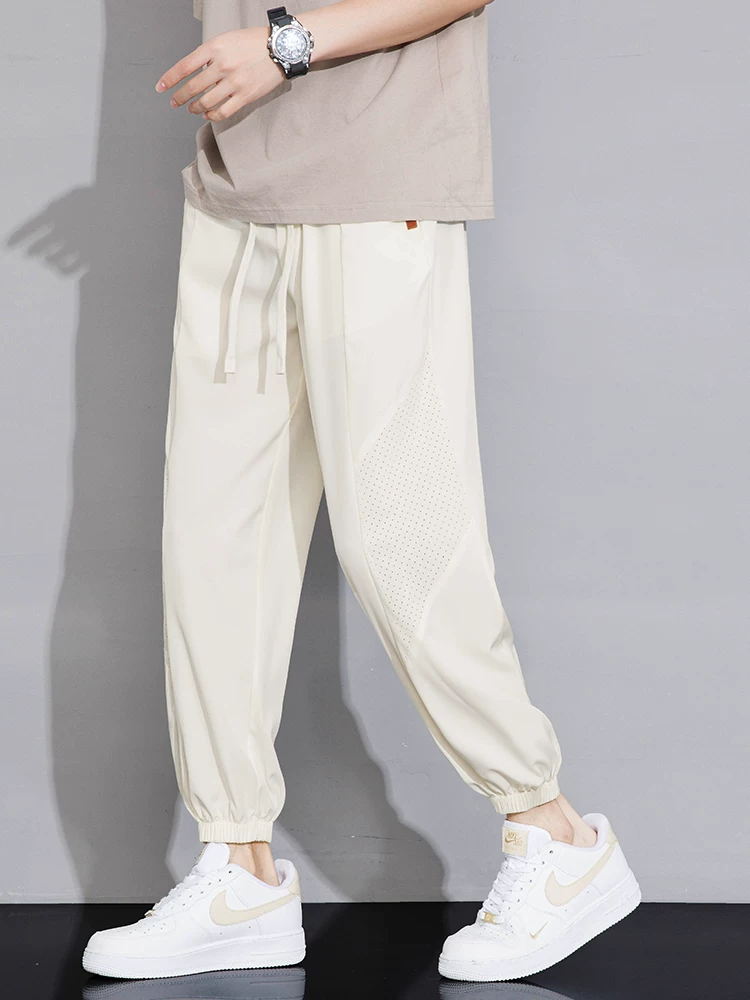 Quần jogger nam Jeanswest 2025 chất liệu lụa đá mỏng, mùa hè, màu trơn, đa năng, dáng rộng, suông, thể thao.