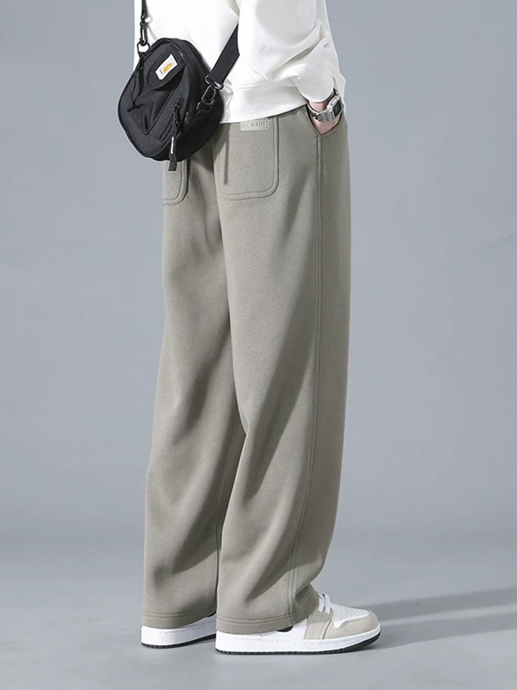 Quần jeanswest đơn sắc đơn giản dành cho nam, phong cách mới mùa xuân thu, quần thể thao ống rộng dáng suông đa năng.