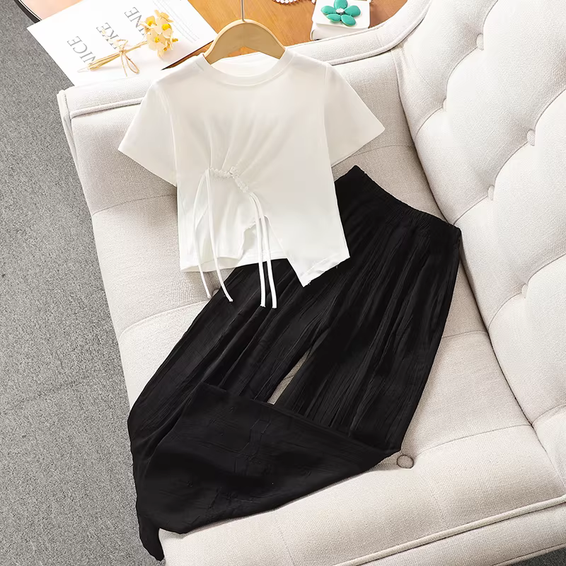 Áo thun bé gái mùa hè 2025 kiểu mới, áo thun ngắn tay xẻ tà chất cotton nguyên chất màu trắng dành cho bé gái lớn