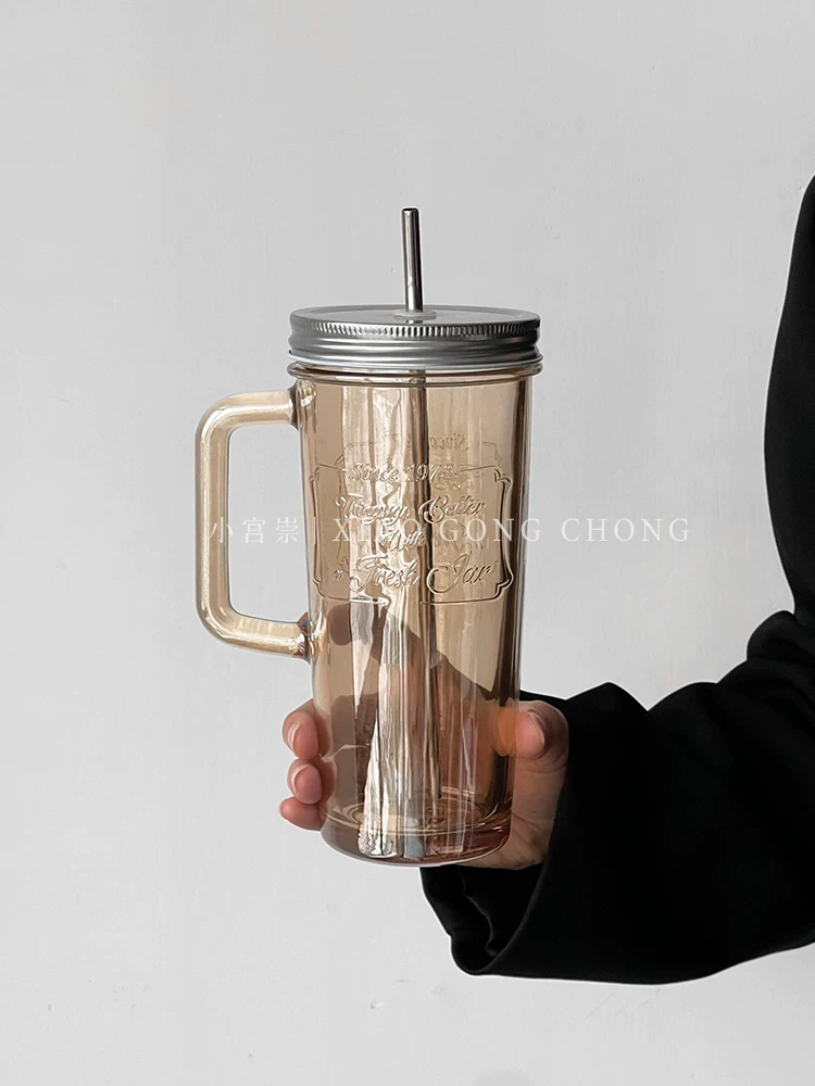 Ly thủy tinh kiểu Mỹ, kiểu dáng bình mason có quai cầm, nắp đậy và ống hút, dung tích lớn, dùng làm ly nước ép, ly cà phê, ly sữa.