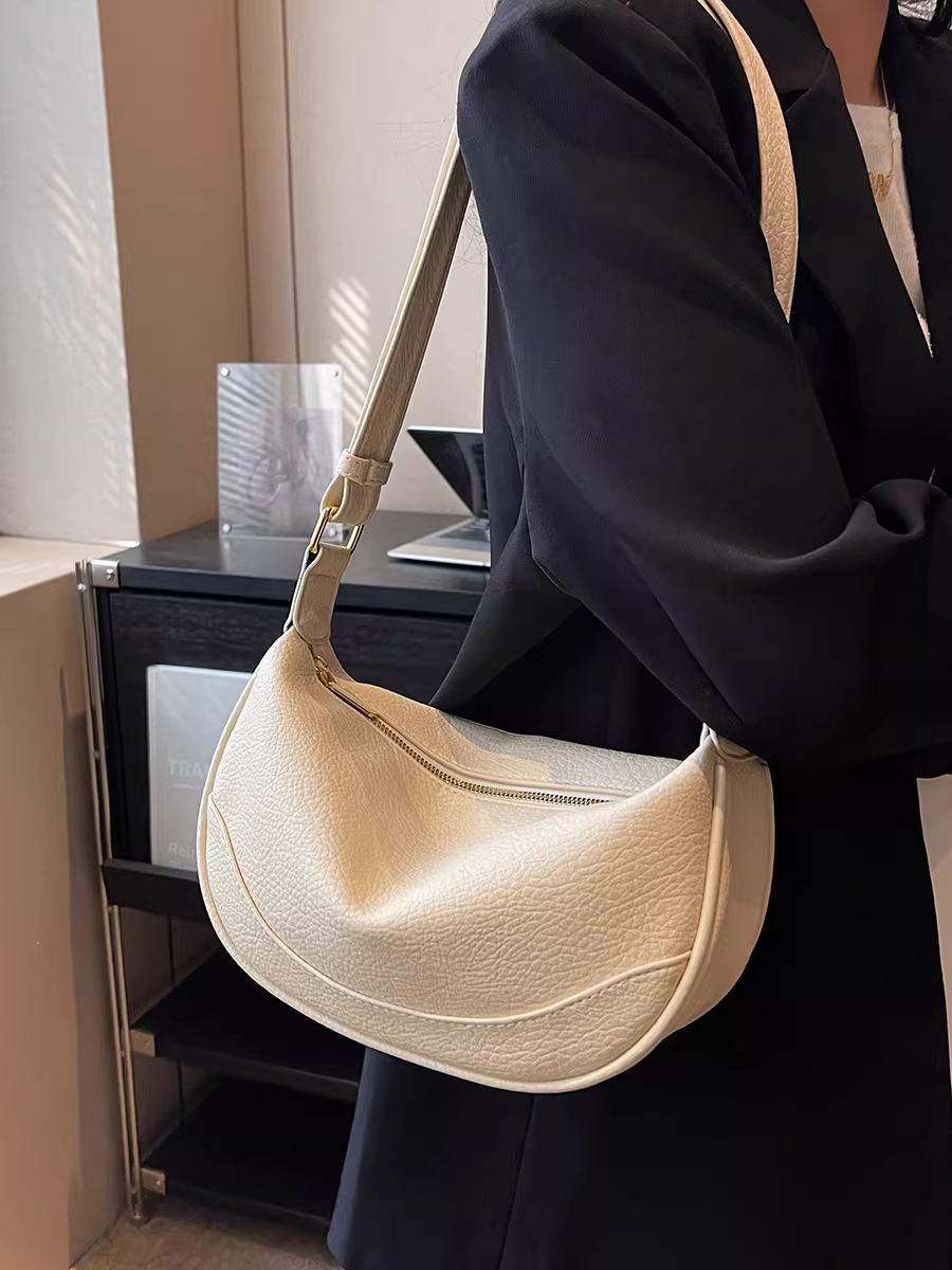 Túi xách thiết kế độc đáo dành cho nữ, dung tích lớn, kiểu dáng mới 2025, chất liệu có vân, thích hợp cho mùa thu đông, đeo vai và đeo chéo, túi bánh bao thời thượng dành cho người đi làm.
