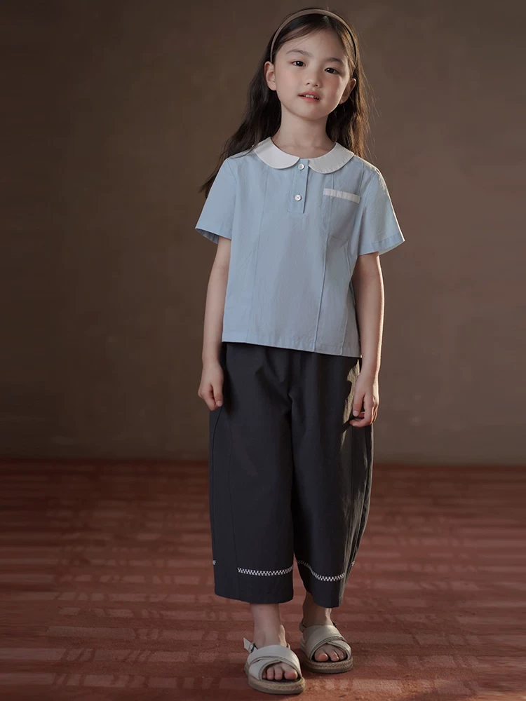 Quần áo trẻ em Hazi Áo trẻ em mùa hè Áo sơ mi ngắn tay phong cách đại học màu xanh Áo sơ mi búp bê dành cho nữ Áo sơ mi cotton thân thiện với da