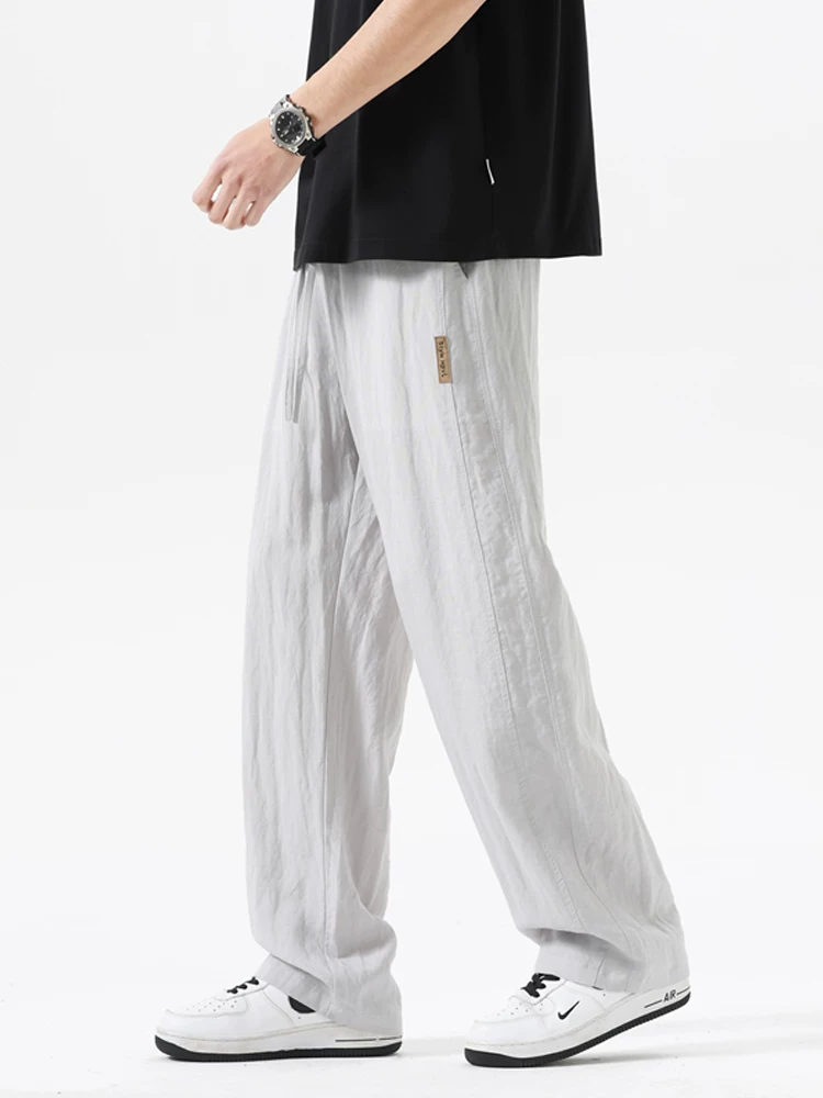Quần dài ống rộng kiểu Mỹ của Jeanswest dành cho nam, mùa xuân thu, quần dài ống rộng có dây rút, quần dài thương hiệu thời trang cao cấp.