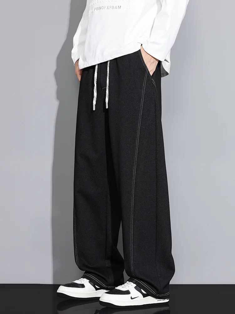 Quần thể thao dệt kim thời trang cao cấp của thương hiệu Jeanswest dành cho nam, quần dài màu đen dáng rộng, suông mềm mại cho mùa xuân hè.