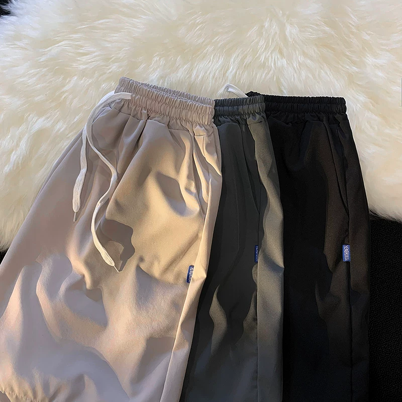 Quần short nam mùa hè chất liệu lụa băng mỏng, quần dài vừa phải màu trơn phong cách thường ngày, kiểu dáng thời thượng Hồng Kông, quần năm phần dáng rộng đa năng.