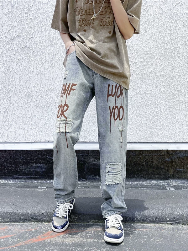 Quần jean rách in họa tiết phong cách đường phố Mỹ dành cho nam, dáng rộng ống thẳng, quần hip-hop hợp thời trang mùa hè dành cho giới trẻ.