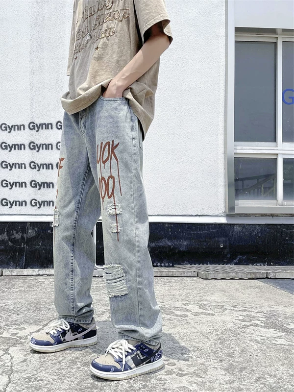 Quần jean rách in họa tiết phong cách đường phố Mỹ dành cho nam, dáng rộng ống thẳng, quần hip-hop hợp thời trang mùa hè dành cho giới trẻ.