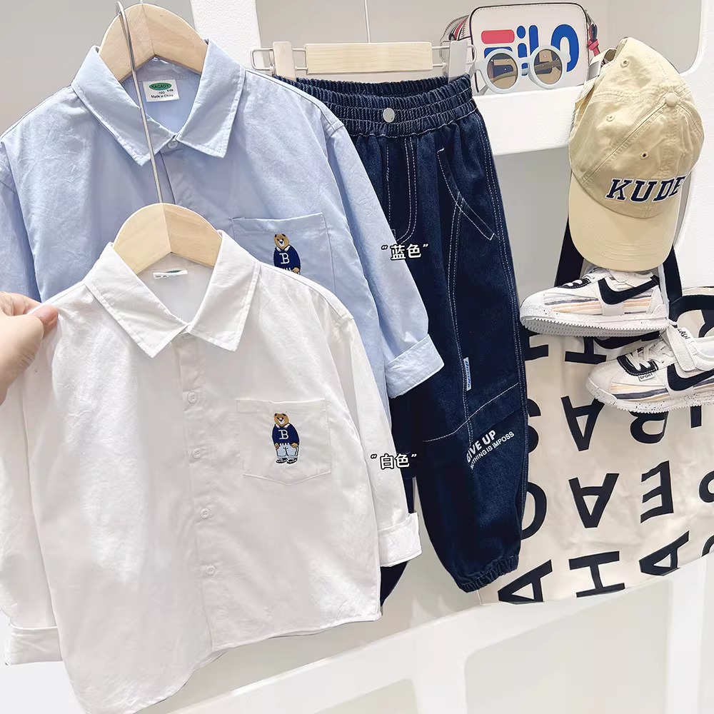 Áo sơ mi trẻ em thêu hình gấu 2025 mẫu mới thu đông bé trai thời trang hoạt hình áo dài tay thu đông phong cách Hàn Quốc