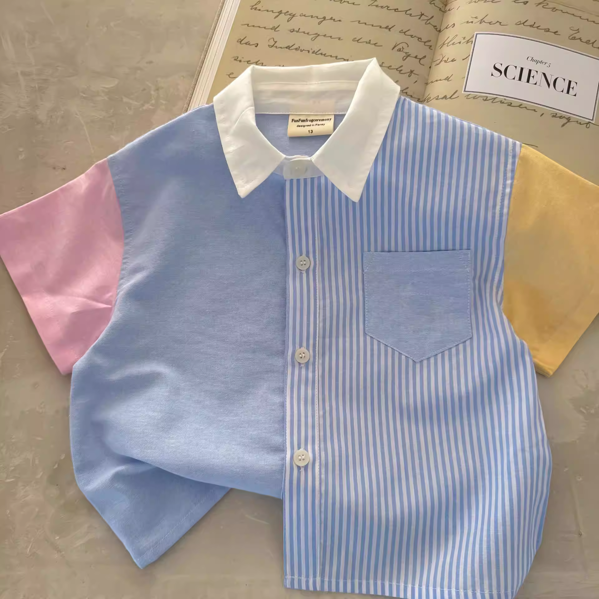 Áo thun ngắn tay trẻ em hè 2025 mẫu mới áo sơ mi sọc bé trai phong cách Hàn Quốc quần áo hè bé gái chất liệu cotton nguyên chất