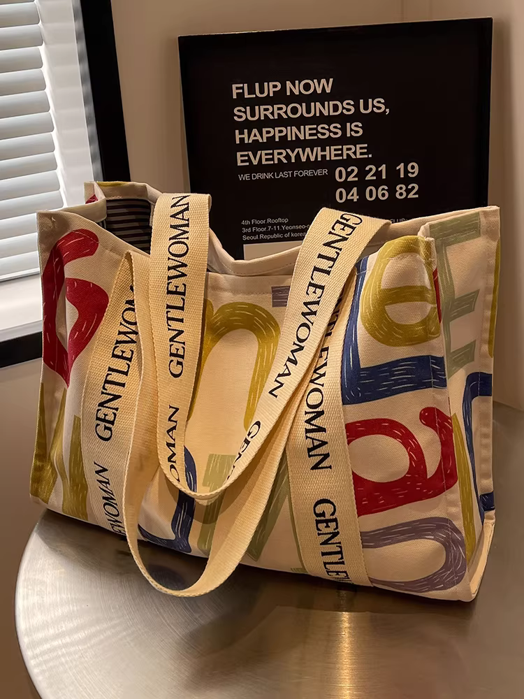 Túi vải canvas dành cho nữ, sức chứa lớn, kiểu dáng mới 2025, giản dị và đa năng, túi đeo vai đi chợ, túi tote đơn giản để đi học và đi làm.