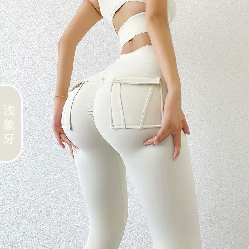 Quần tập thể dục nữ có nâng mông và có túi, quần tập thể thao, quần yoga trắng thể thao, phong cách thu đông mới gợi cảm.