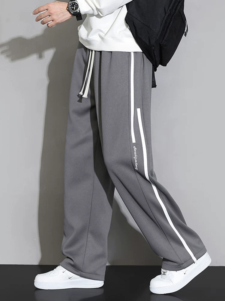 Quần dài thể thao sọc thẳng kiểu Mỹ của Jeanswest dành cho nam, mùa xuân thu, cảm giác cao cấp, dáng rộng, quần dài thể thao đa năng.