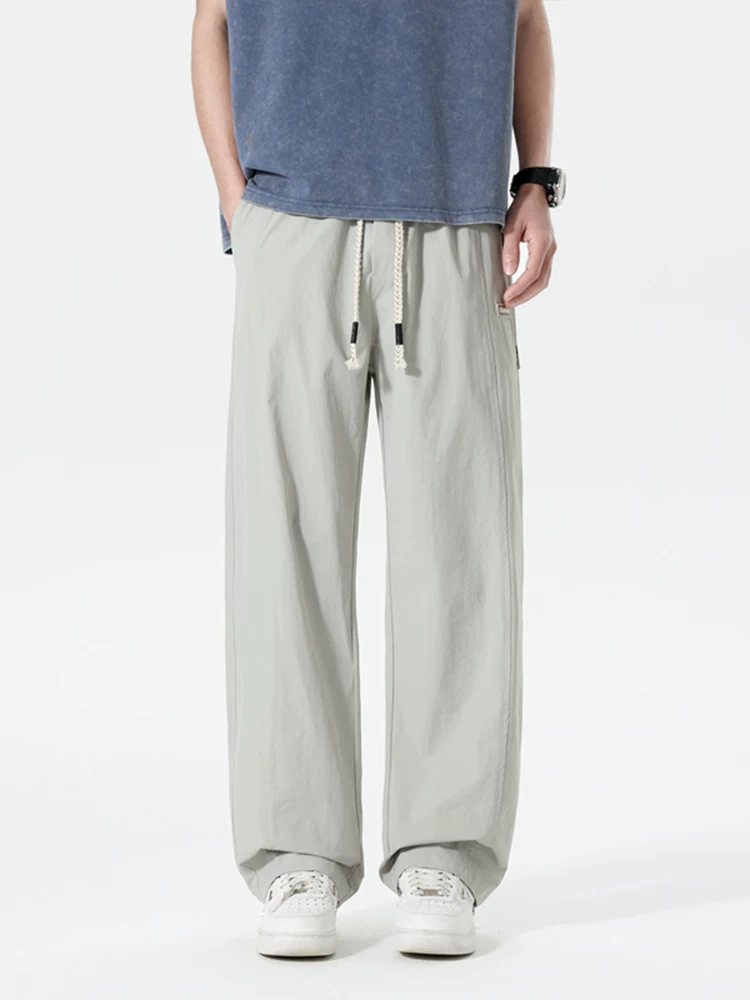 Quần dài thể thao ống đứng phong cách Mỹ thời thượng của Jeanswest dành cho nam, mùa xuân hè, cảm giác cao cấp, dáng rộng, đa năng, thoáng khí.
