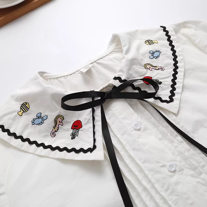 Áo sơ mi cotton thêu hình động vật biển phong cách mới Thu 2021 Dream Box, cổ búp bê, tay dài, dáng rộng, màu trắng dành cho nữ