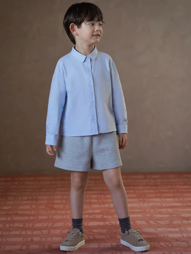 Quần áo trẻ em mùa xuân thu áo sơ mi màu xanh đơn giản đa năng áo sơ mi dài tay cho bé trai và bé gái dành cho trẻ lớn hơn