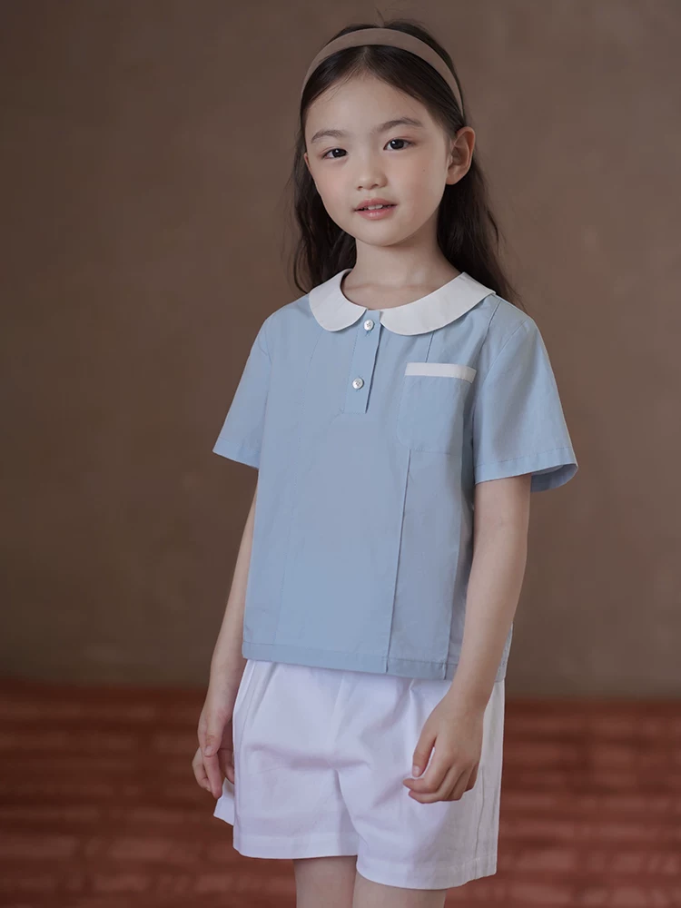 Quần áo trẻ em Hazi Áo trẻ em mùa hè Áo sơ mi ngắn tay phong cách đại học màu xanh Áo sơ mi búp bê dành cho nữ Áo sơ mi cotton thân thiện với da