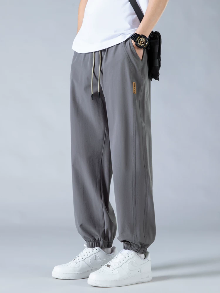 Quần jogger nam Jeanswest Ice Silk mỏng kiểu Mỹ thời trang thương hiệu nổi tiếng mùa hè 2025 mới, dáng rộng, đa năng, phong cách thường ngày