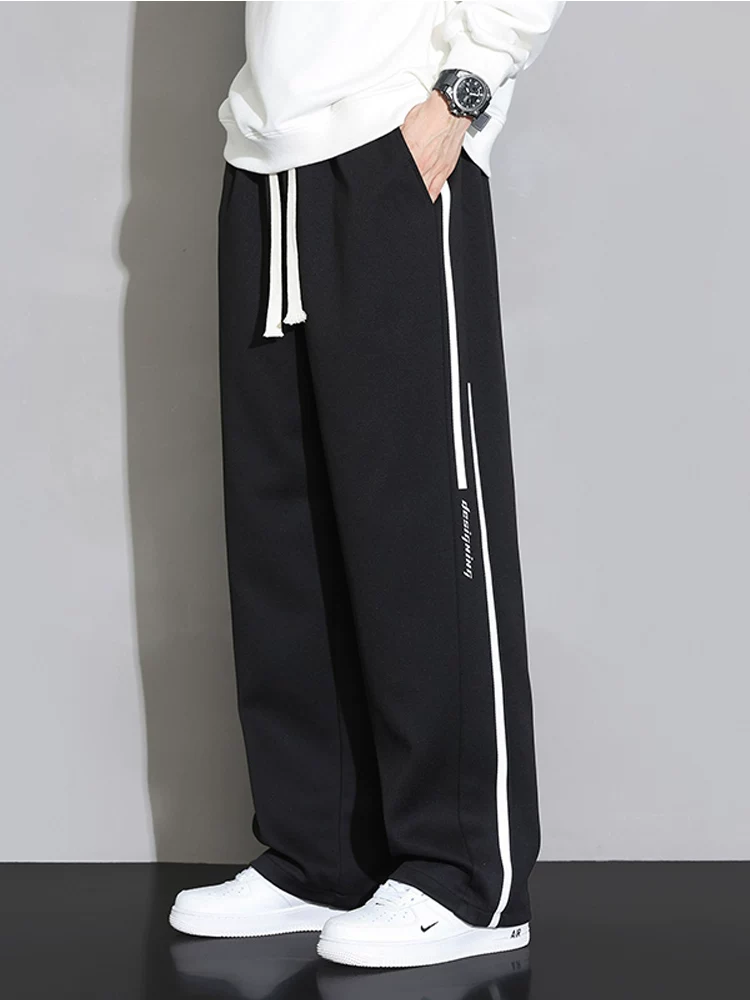 Quần dài thể thao sọc thẳng kiểu Mỹ của Jeanswest dành cho nam, mùa xuân thu, cảm giác cao cấp, dáng rộng, quần dài thể thao đa năng.