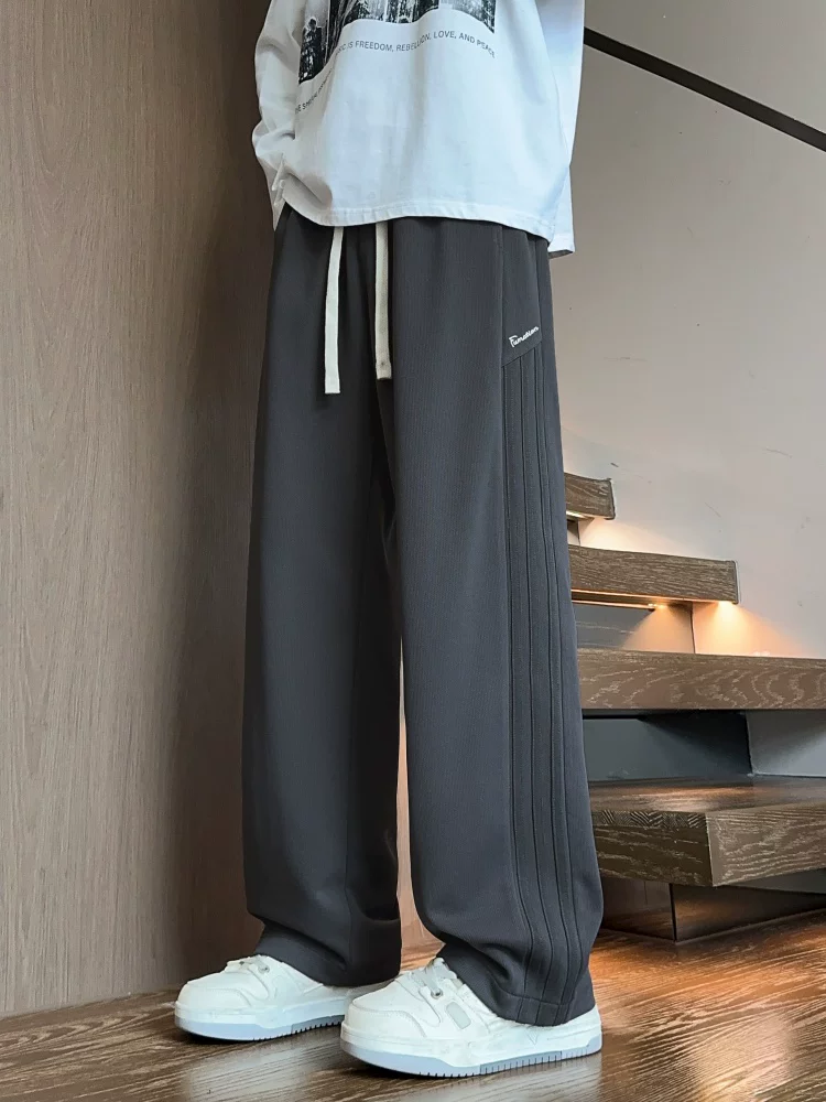 Quần dài ống đứng màu đen phong cách Mỹ của Jeanswest dành cho nam, mẫu mới mùa xuân 2026, quần dài cao cấp, quần thể thao.