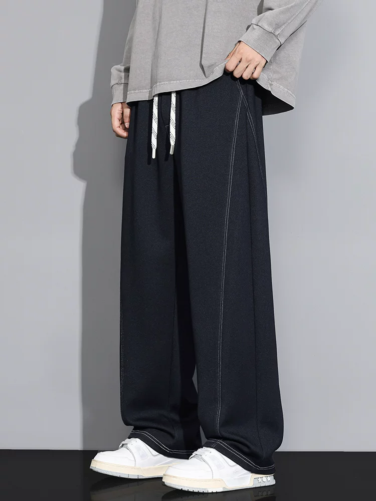Quần thể thao dệt kim thời trang cao cấp của thương hiệu Jeanswest dành cho nam, quần dài màu đen dáng rộng, suông mềm mại cho mùa xuân hè.
