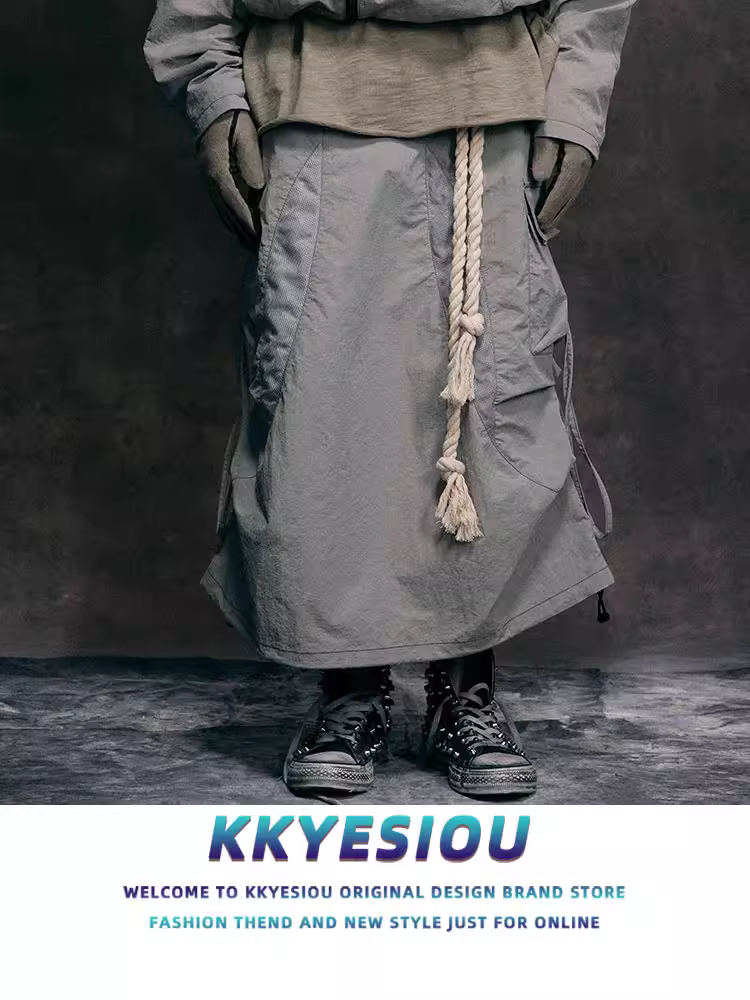 Váy công sở nữ kiểu dáng năng động, chất liệu vải bố, thiết kế dây buộc, xếp ly, phong cách đường phố Mỹ, dài ngang đùi.