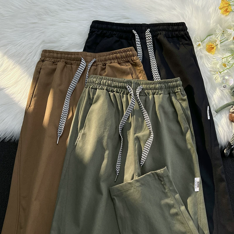 Quần công sở màu trơn cơ bản mùa xuân thu thương hiệu thời trang phong cách Nhật Bản quần nam giản dị đa năng quần dài ống rộng